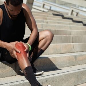 closeup young man with knee injury