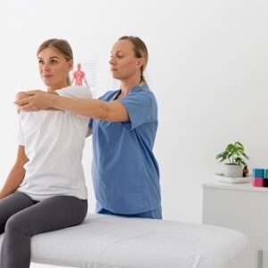 physiotherapist helping female patient her clinic 1 1