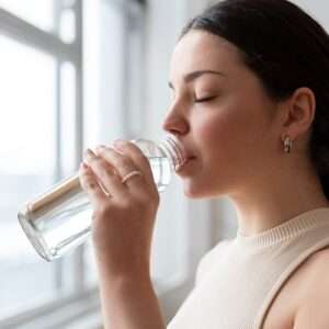 woman drinking water after exercise 1